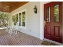 Inviting front porch with rocking chairs and brick flooring at 352 Old Carriage Loop, Georgetown, SC 29440