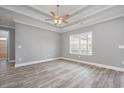 Spacious bedroom with light gray walls, ceiling fan and trim and a bright window at 357 Log Cabin Rd., Loris, SC 29569