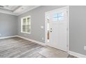 Bright entryway featuring a white door with glass panes, light gray walls, and wood-look floors at 357 Log Cabin Rd., Loris, SC 29569