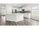 Bright kitchen featuring an island, stainless steel appliances, and white cabinetry at 3725 Park Pointe Ave., Little River, SC 29566