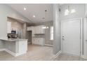 Bright, open-concept interior showcases white cabinets, stainless appliances, and modern lighting at 375 Log Cabin Rd., Loris, SC 29569