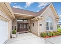 Elegant entrance with double doors, detailed windows, brick facade and manicured landscaping at 3757 Kingsley Dr., Myrtle Beach, SC 29588