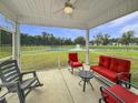Relaxing screened porch with comfortable seating and serene views of the pond with fountain at 40 Little Peru Ct., Georgetown, SC 29440