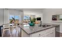 Modern kitchen featuring granite countertops, stainless steel appliances, and an adjacent dining area at 402 Glade Ct., Loris, SC 29569