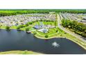 A stunning aerial view of the community amenities, including a pool, clubhouse, and lake with a fountain at 448 Papyrus Circle # 448, Little River, SC 29566