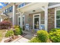 Inviting front porch with rocking chairs and nautical decor, perfect for relaxing and enjoying the outdoors at 448 Papyrus Circle # 448, Little River, SC 29566