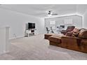 Large carpeted bonus room with a ceiling fan offers versatility as a media room, office, or play area at 452 Sun Colony Blvd., Longs, SC 29568