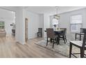 Bright dining room featuring stylish furnishings, wood-look floors and neutral walls at 452 Sun Colony Blvd., Longs, SC 29568