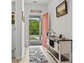 Bright entryway with a console table, wood floors, and an orange front door at 452 Sun Colony Blvd., Longs, SC 29568