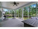 Relaxing screened porch with comfortable seating and views of the backyard and surrounding greenery at 452 Sun Colony Blvd., Longs, SC 29568
