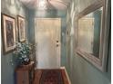 Entry way featuring a coat closet, with a decorative light and picture frames at 5001 Little River Rd. # E-117-119, Myrtle Beach, SC 29577