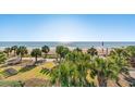 Beach view from building overlooking ocean, palm trees, and lounge seating at 504 N Ocean Blvd. N # 309, Myrtle Beach, SC 29577