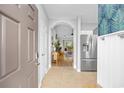 Inviting hallway with tile floors leads to an open living space, complemented by a modern stainless-steel refrigerator at 5750 Oyster Catcher Dr. # 333, North Myrtle Beach, SC 29582