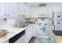Bright, clean kitchen with white cabinets, subway tile backsplash, and stainless steel sink at 6001 N Ocean Blvd. # 342, North Myrtle Beach, SC 29582