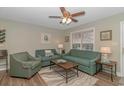 Bright living room with two sofas, stylish ceiling fan, and beach-themed decor at 6001-8026 South Kings Hwy., Myrtle Beach, SC 29575