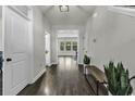 Inviting hallway with hardwood floors, neutral paint, and views into dining and living areas at 6239 Chadderton Circle, Myrtle Beach, SC 29579