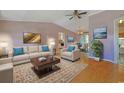 Bright living room featuring a comfortable sofa, stylish rug, and an abundance of natural light at 6544 Amberwood Ct., Myrtle Beach, SC 29588