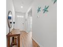 Bright entryway featuring wood floors, decorative accents, and a clear view to interior at 662 Wallace Dr., Little River, SC 29566