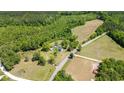Sprawling property showcasing the home's serene setting with abundant trees and open fields at 675 Liberty Church Rd., Loris, SC 29569