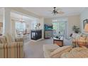 Spacious living room with fireplace open to dining area with views of the outdoor balcony at 719 Shearwater Ct. # 301, Murrells Inlet, SC 29576