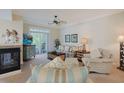 Inviting living room featuring a fireplace, comfortable seating, ceiling fan, and sliding doors to the exterior at 719 Shearwater Ct. # 301, Murrells Inlet, SC 29576