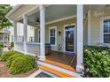 Inviting front porch with a cozy seating area, ceiling fan, and a charming welcome sign at 830 Shine Ave. # 28 R8, Myrtle Beach, SC 29577