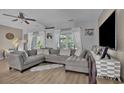 Cozy living room with a sectional sofa, large windows, and stylish decor at 9232 Goodwill Ct., Myrtle Beach, SC 29579