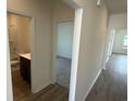 Bright hallway leading to the bathroom and carpeted bedroom at 1029 Jase Dr., Longs, SC 29568