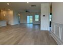 Spacious, light-filled living area with wood-look flooring and sliding glass doors to the backyard at 1033 Jase Dr., Longs, SC 29568