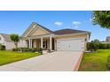 Inviting single-Gathering home showcasing a well-maintained lawn, complemented by a spacious two-car garage at 1035 Brentford Pl., Myrtle Beach, SC 29579