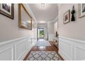 Inviting hallway with hardwood floors and elegant wall decor, leading to the home's entrance at 1035 Brentford Pl., Myrtle Beach, SC 29579