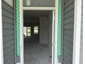 View from the front porch into the home featuring an open floorplan and sliding glass doors to the backyard at 1037 Jase Dr., Longs, SC 29568