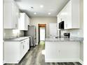 Spacious kitchen with white cabinets, granite countertops, stainless steel appliances, and modern finishes at 104 Jessica Lakes Dr., Conway, SC 29526