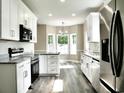 Bright kitchen featuring modern stainless steel appliances, granite counters, and a breakfast nook with great light at 104 Jessica Lakes Dr., Conway, SC 29526