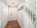 Bright entryway with hardwood floors, fresh paint and a staircase with white railings at 1379 Cottage Dr., Myrtle Beach, SC 29577
