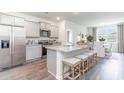 Modern kitchen with stainless steel appliances, an island with seating, and an adjacent dining area at 1398 Nokota Dr., Conway, SC 29526