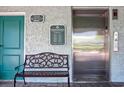 Community building entrance with elevator, signage and seating near the door at 14290 Ocean Hwy. # 312, Pawleys Island, SC 29585