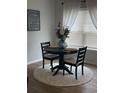 Bright breakfast nook featuring a round table, seating for two, and decorative floral centerpiece at 1565 Jardine Loop, Little River, SC 29566