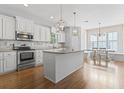 Spacious kitchen with granite countertops, stainless steel appliances, and a large center island at 18 Coastal Breeze Trail, Pawleys Island, SC 29585