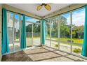 Bright sunroom with large windows offering ample sunlight and serene backyard views at 1808 Zodiac Court, Myrtle Beach, SC 29577