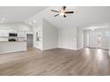 Bright living room features wood-look floors and neutral paint, open to kitchen and dining areas at 192 Six Mile Creek Dr., Georgetown, SC 29440