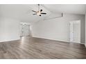 Spacious living room boasts wood-look floors, modern ceiling fan, and plenty of natural light at 192 Six Mile Creek Dr., Georgetown, SC 29440