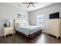 Cozy bedroom features wood floors, dresser, TV, and window at 200 53Rd Ave. N # 511, North Myrtle Beach, SC 29582