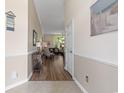 Inviting hallway leading to a bright living area with hardwood floors and neutral decor at 205 Carriage Lake Dr., Little River, SC 29566
