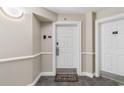Condo entrance featuring a welcome mat, unit number, and a secured door with a modern handle at 215 77Th Ave. N # 702, Myrtle Beach, SC 29572