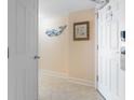 Hallway with tile flooring, a decorative whale hook, a framed print and a modern door with digital lock at 215 77Th Ave. N # 702, Myrtle Beach, SC 29572