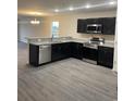 Modern kitchen boasts stainless steel appliances, granite countertops, and dark cabinetry at 2247 Union Church Rd., Little River, SC 29566