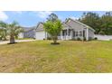 Lovely home with a cozy front porch, green lawn, and a two-car garage perfect for suburban living at 247 Dempsey Dr., Loris, SC 29569