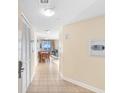 Tile hallway leading to open living area with balcony access and dining table at 2501 S Ocean Blvd. # 831, Myrtle Beach, SC 29577