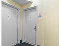 Hallway view with white doors, unit number 831, blue carpet, and pale-yellow walls at 2501 S Ocean Blvd. # 831, Myrtle Beach, SC 29577